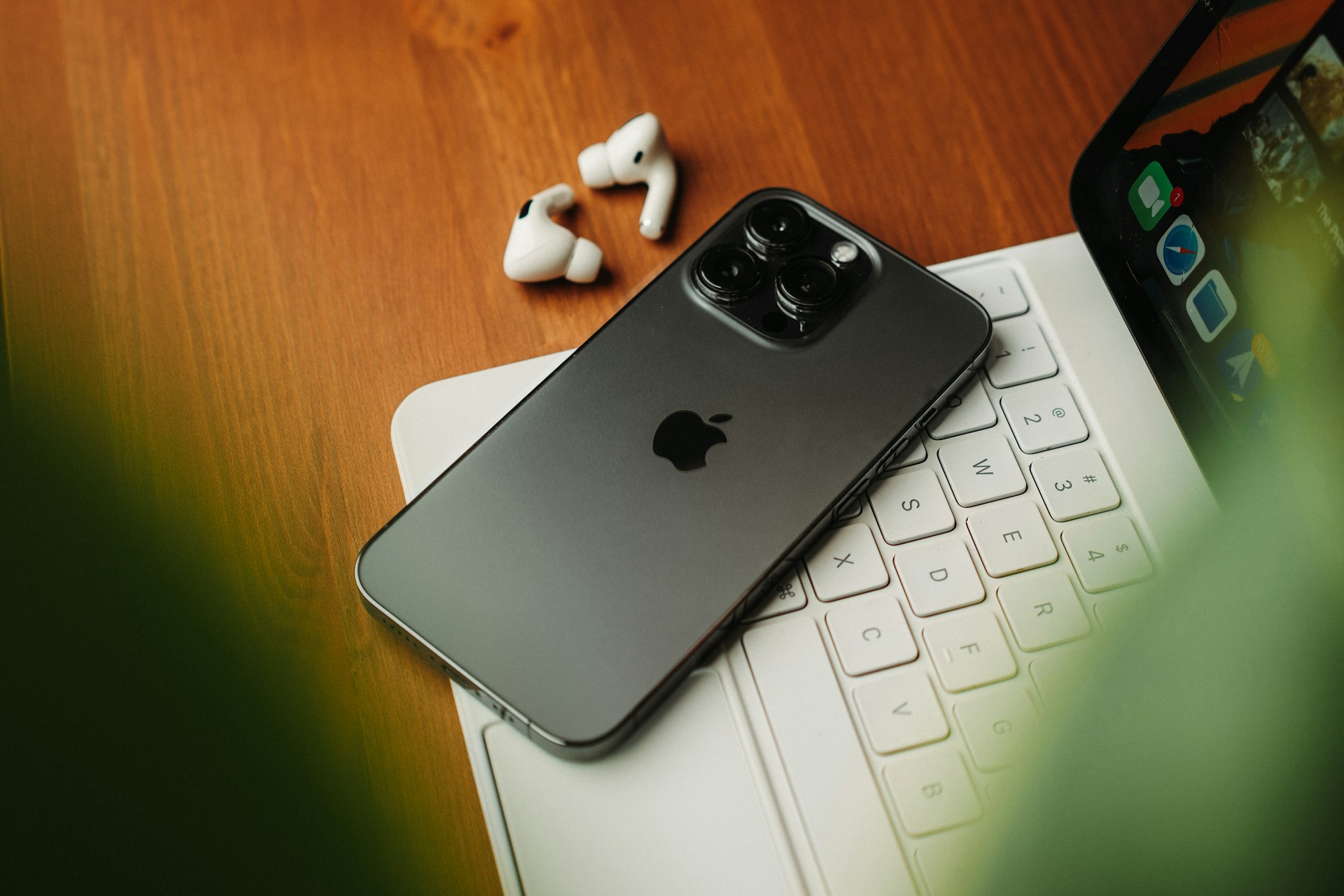 Smartphone, earbuds and tablet on a desk